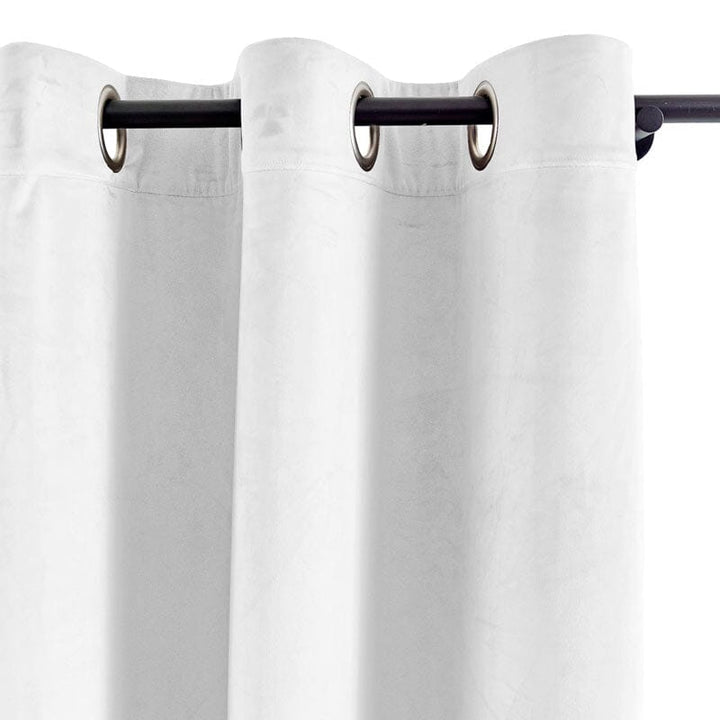 White grommet curtains with a smooth texture and elegant draping.