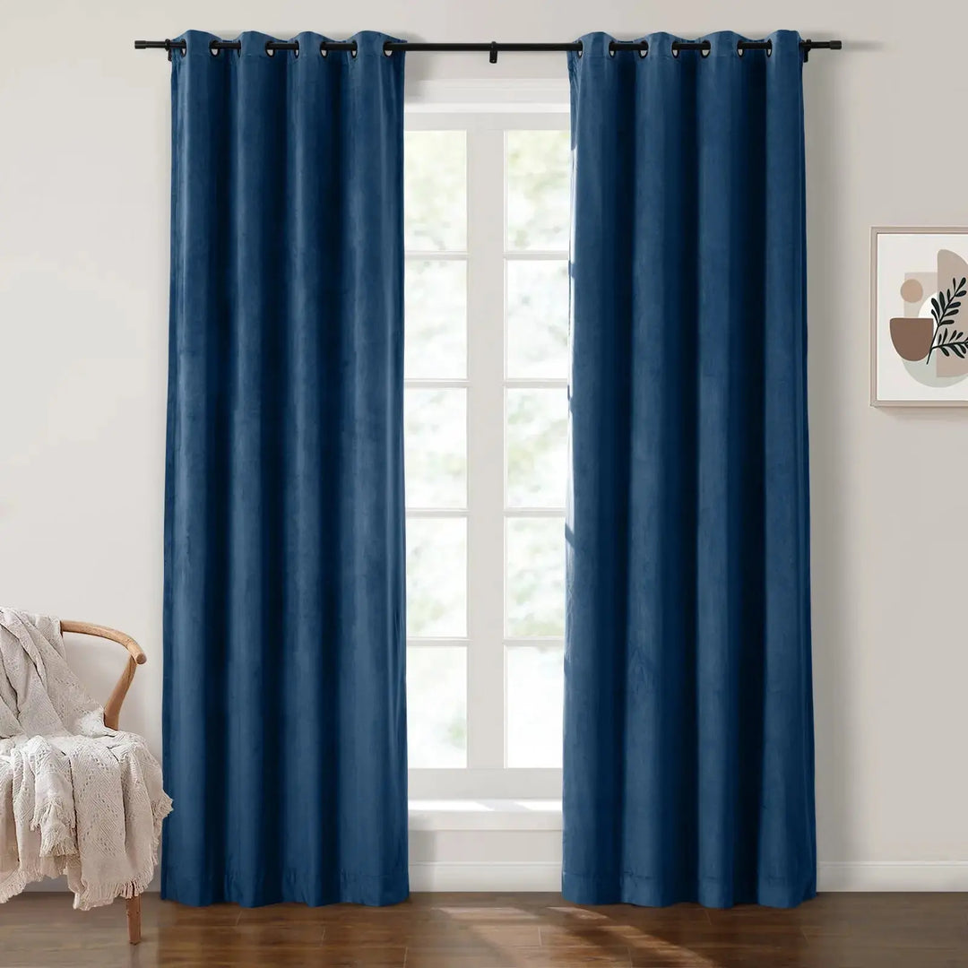 Deep blue grommet curtains elegantly framing large windows in a bright living room.