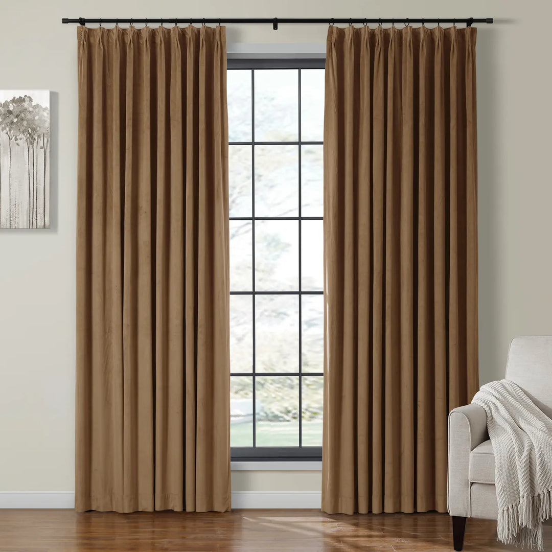 Beige velvet curtains elegantly framing a large window in a cozy living room.