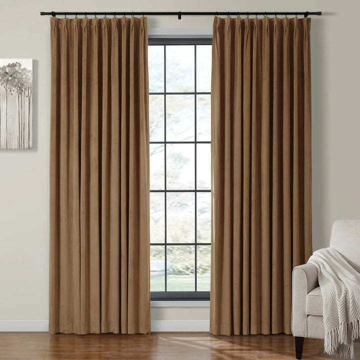 Beige velvet curtains elegantly framing a large window in a cozy living room.
