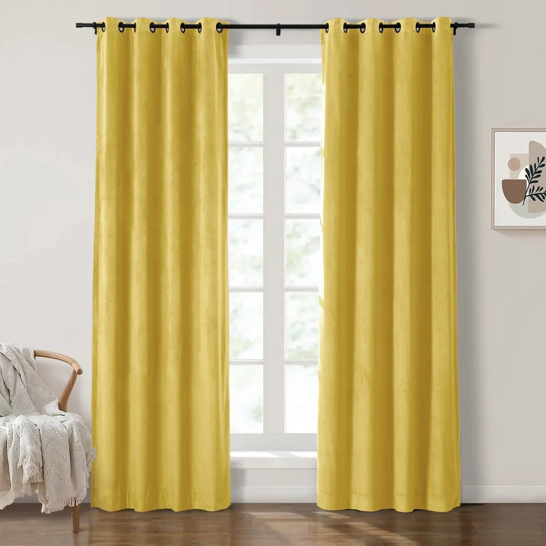 Mustard yellow grommet curtains framing large windows in a bright living room.