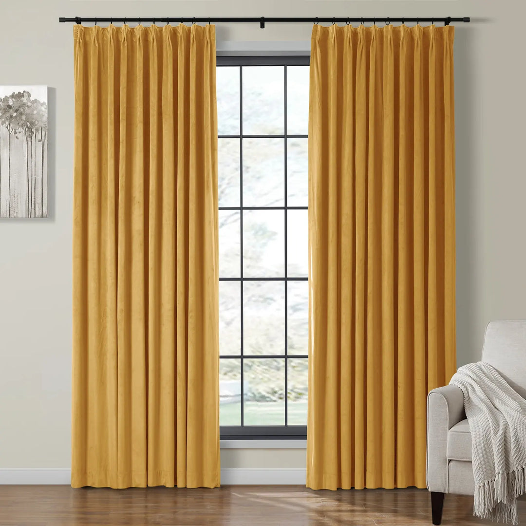 Pleated yellow velvet curtains framing a bright window in a cozy living room.