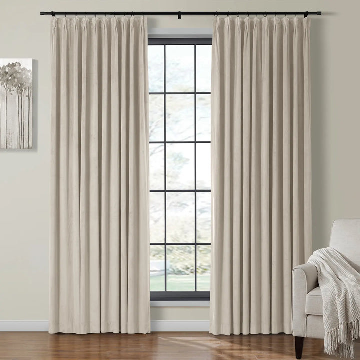 Cream velvet curtains gracefully framing a bright window in a cozy living room.