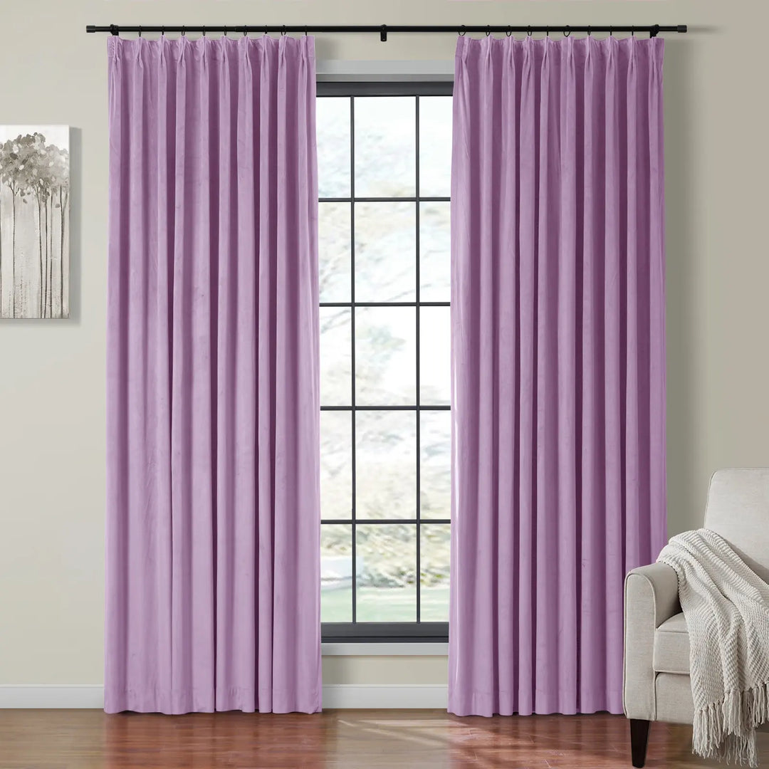 Pleated lavender velvet curtains on black rod framing a bright window in living room.