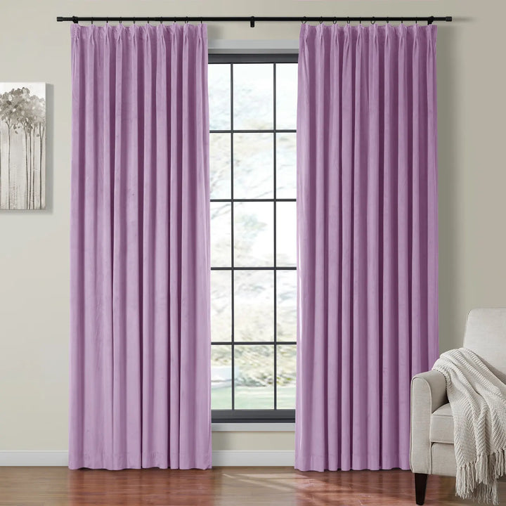 Pleated lavender velvet curtains on black rod framing a bright window in living room.