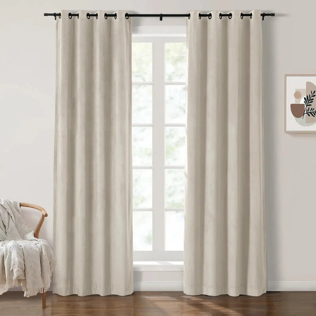 Beige grommet curtains framing large windows in a bright living room.