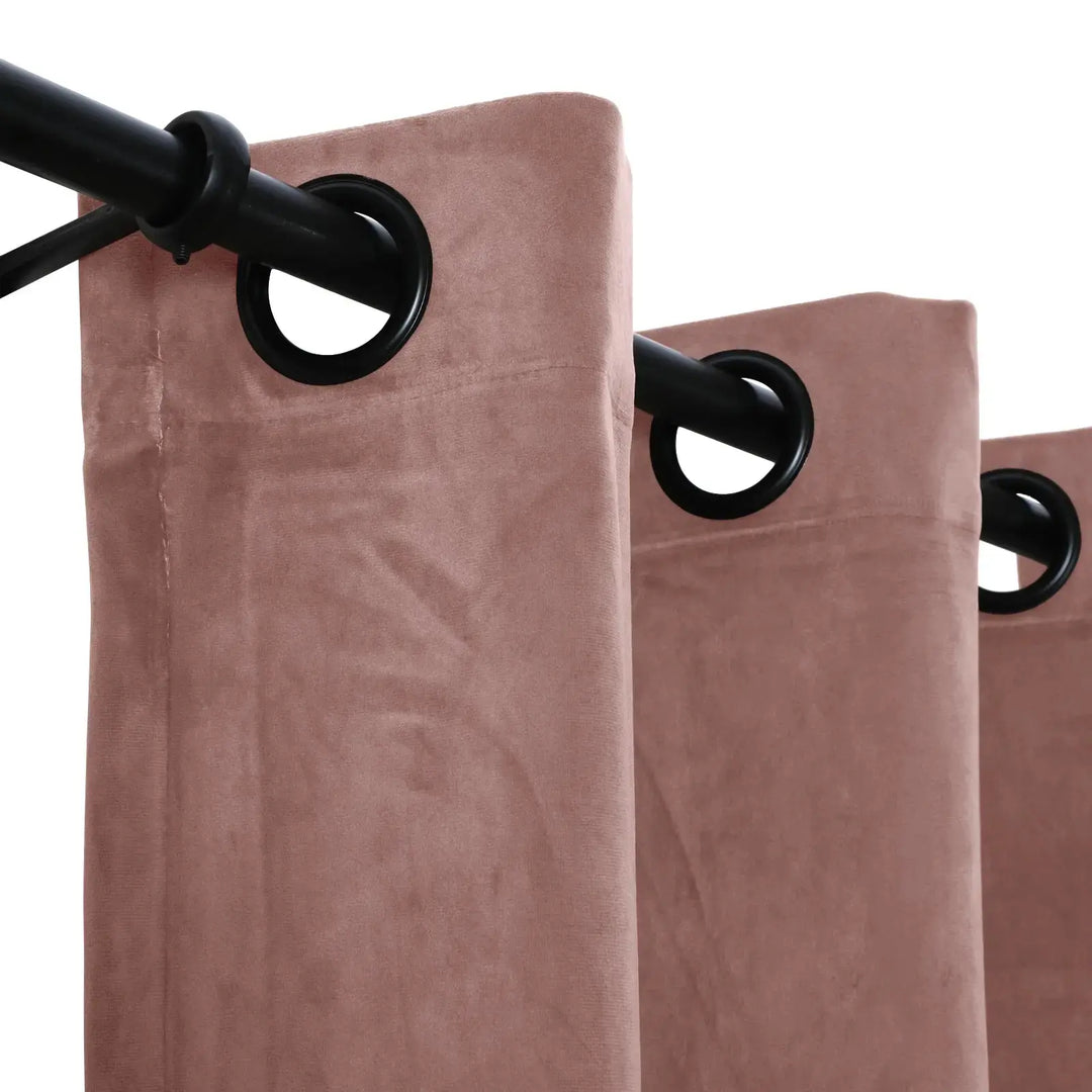 Close-up of blush velvet grommet curtains showcasing texture and sheen.