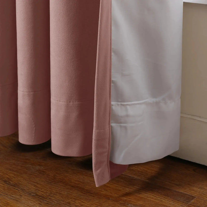Blush velvet curtain layered over a white curtain panel, highlighting soft texture and elegance.