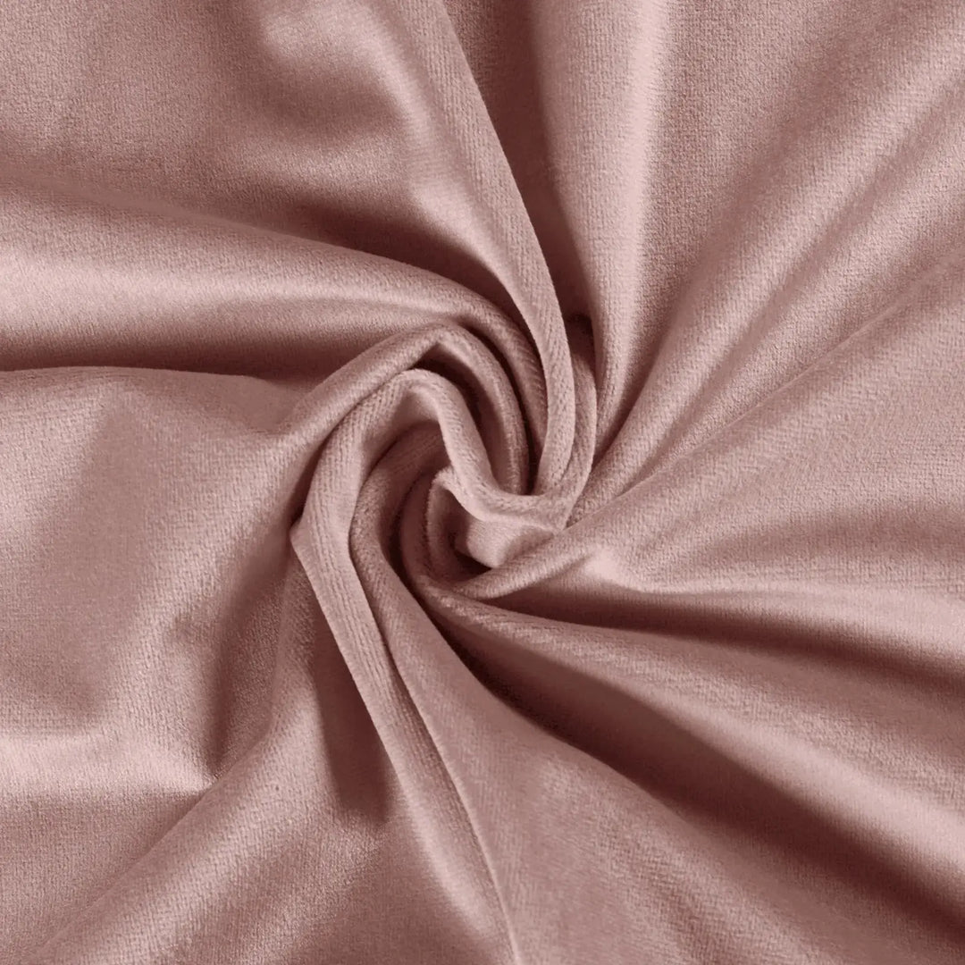 Close-up of soft blush velvet fabric showcasing smooth texture and elegant draping.