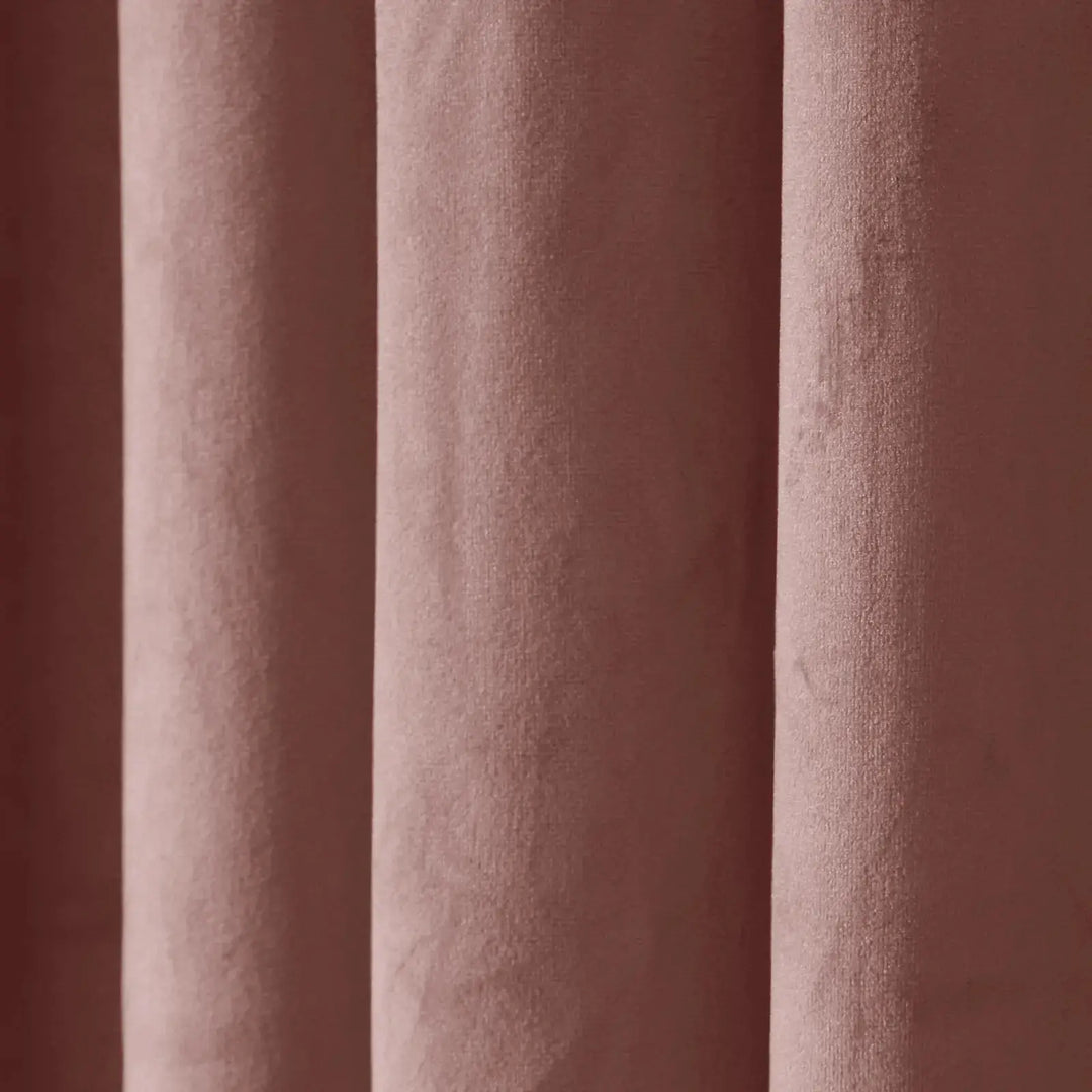 Soft blush velvet texture of drapery highlighting elegance and warmth.