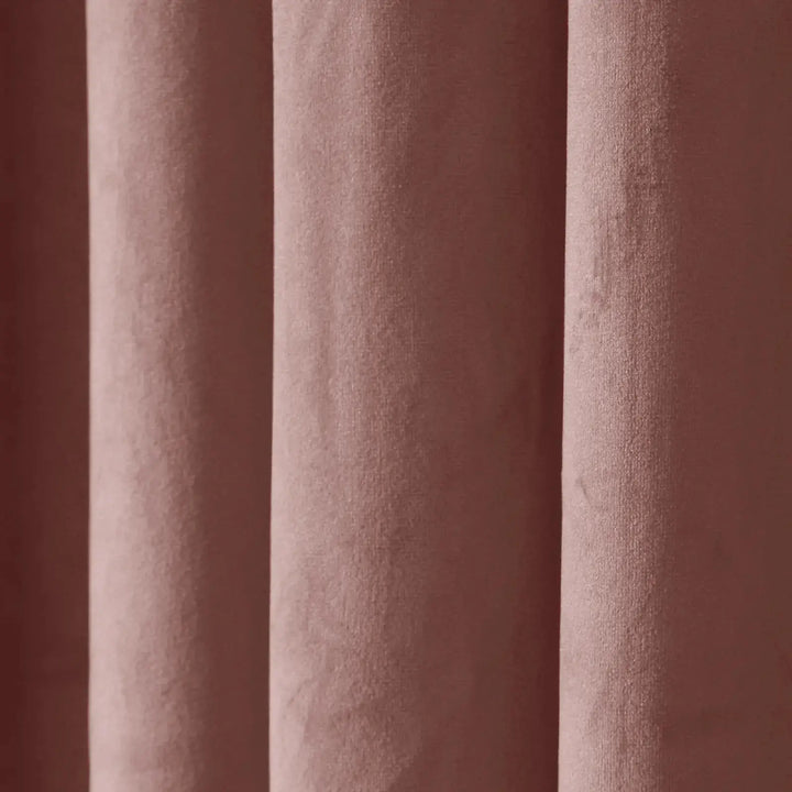Soft blush velvet texture of drapery highlighting elegance and warmth.