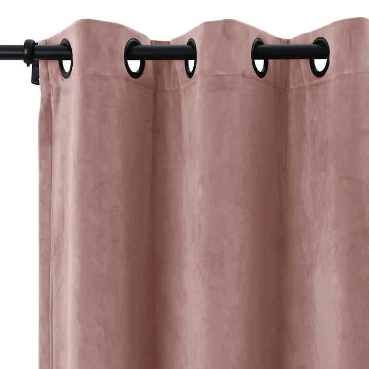 Blush velvet grommet curtains with a smooth texture, perfect for light dimming.