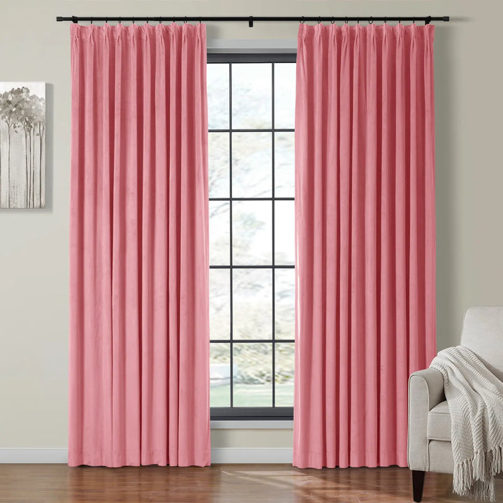 Soft pink velvet curtains draping elegantly beside a large window in a cozy living room.