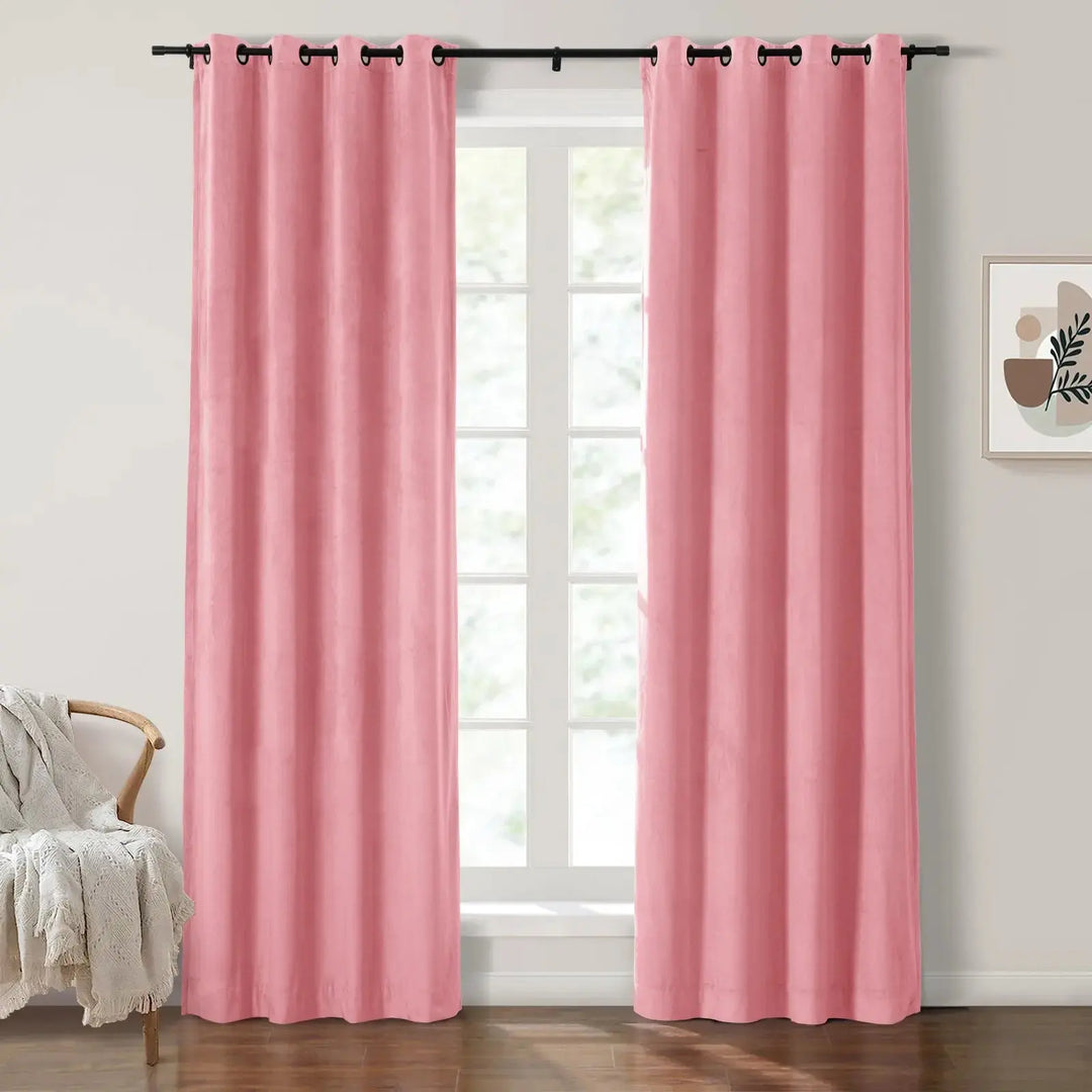Soft blush velvet grommet curtains framing large windows in a bright room.