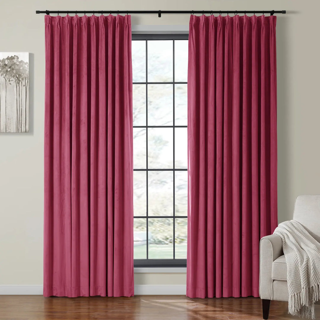 Elegant pink velvet curtains draping beside a bright window in a cozy living room.