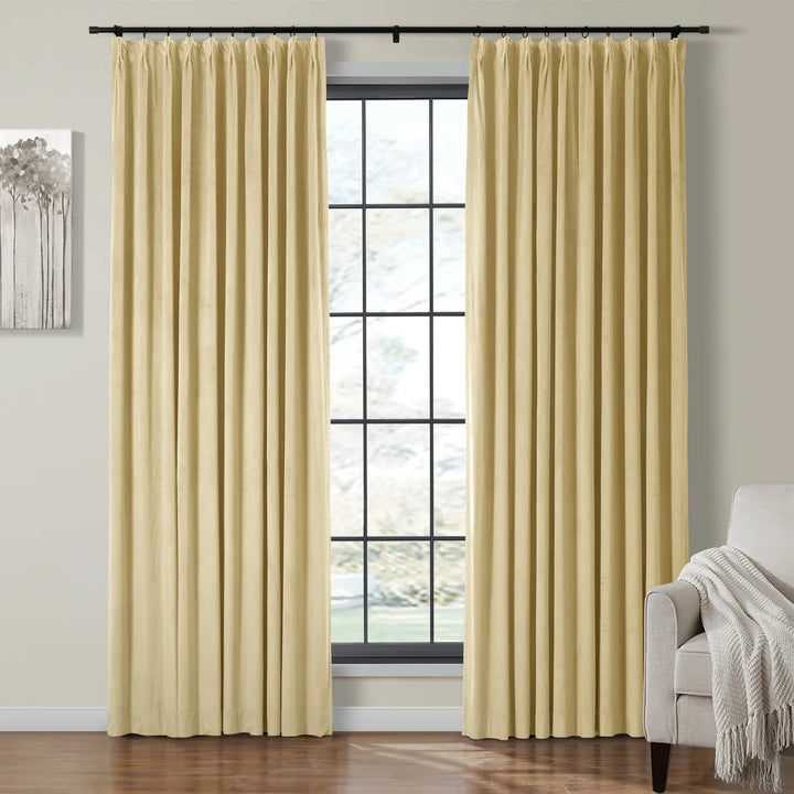 Light yellow velvet curtains flanking a large window in a cozy living room setting.