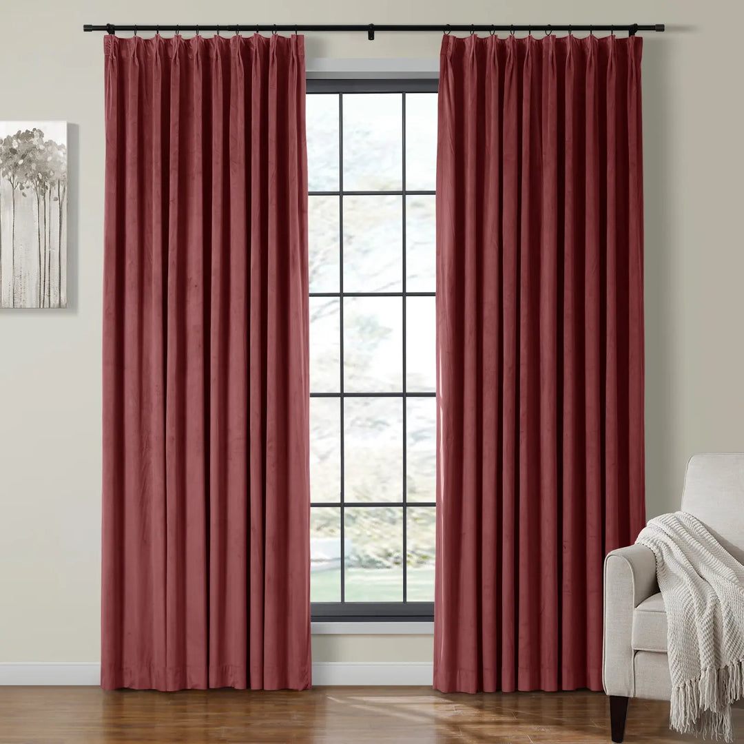 Red velvet curtains draping elegantly beside bright window in cozy living room.
