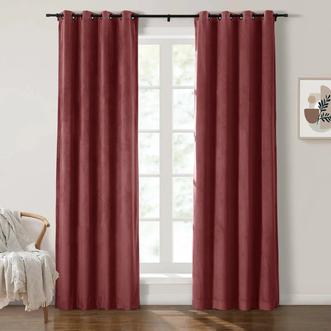 Red grommet curtains enhancing natural light in a cozy living room.