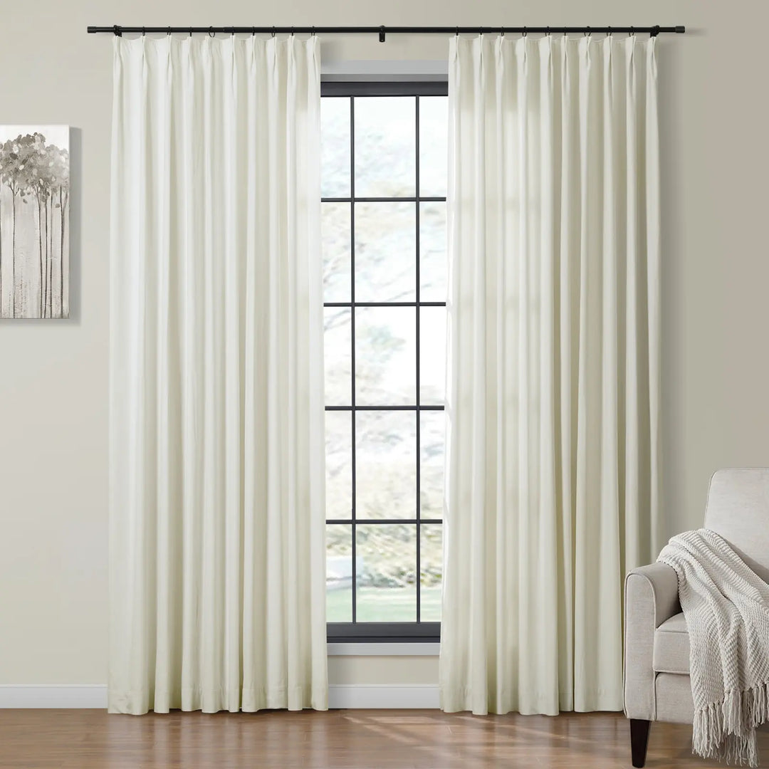 Cream velvet curtains framing a large window in a bright living room