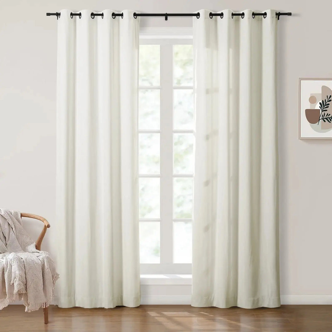 White grommet curtains in bright room with natural light and cozy decor.