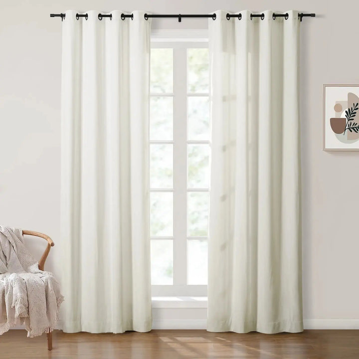 White grommet curtains in bright room with natural light and cozy decor.