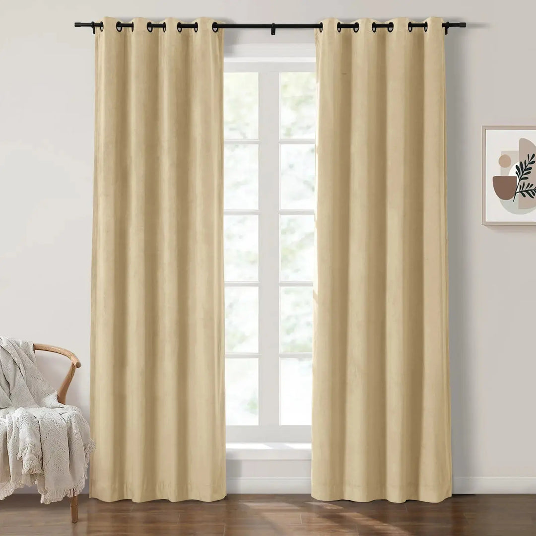 Light beige grommet curtains enhancing brightness in a bright living room with large windows.