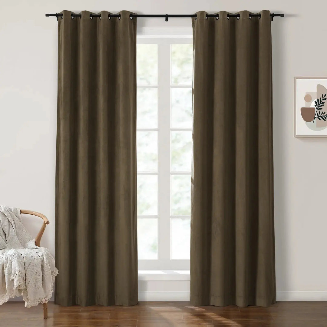 Dark olive green grommet curtains framing large windows in a bright room.