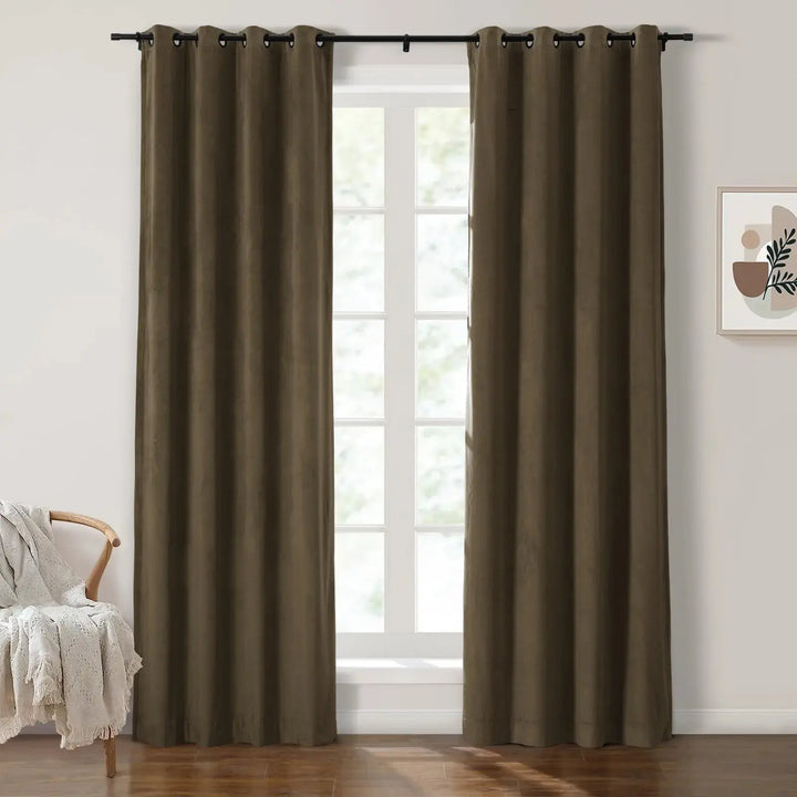 Dark olive green grommet curtains framing large windows in a bright room.