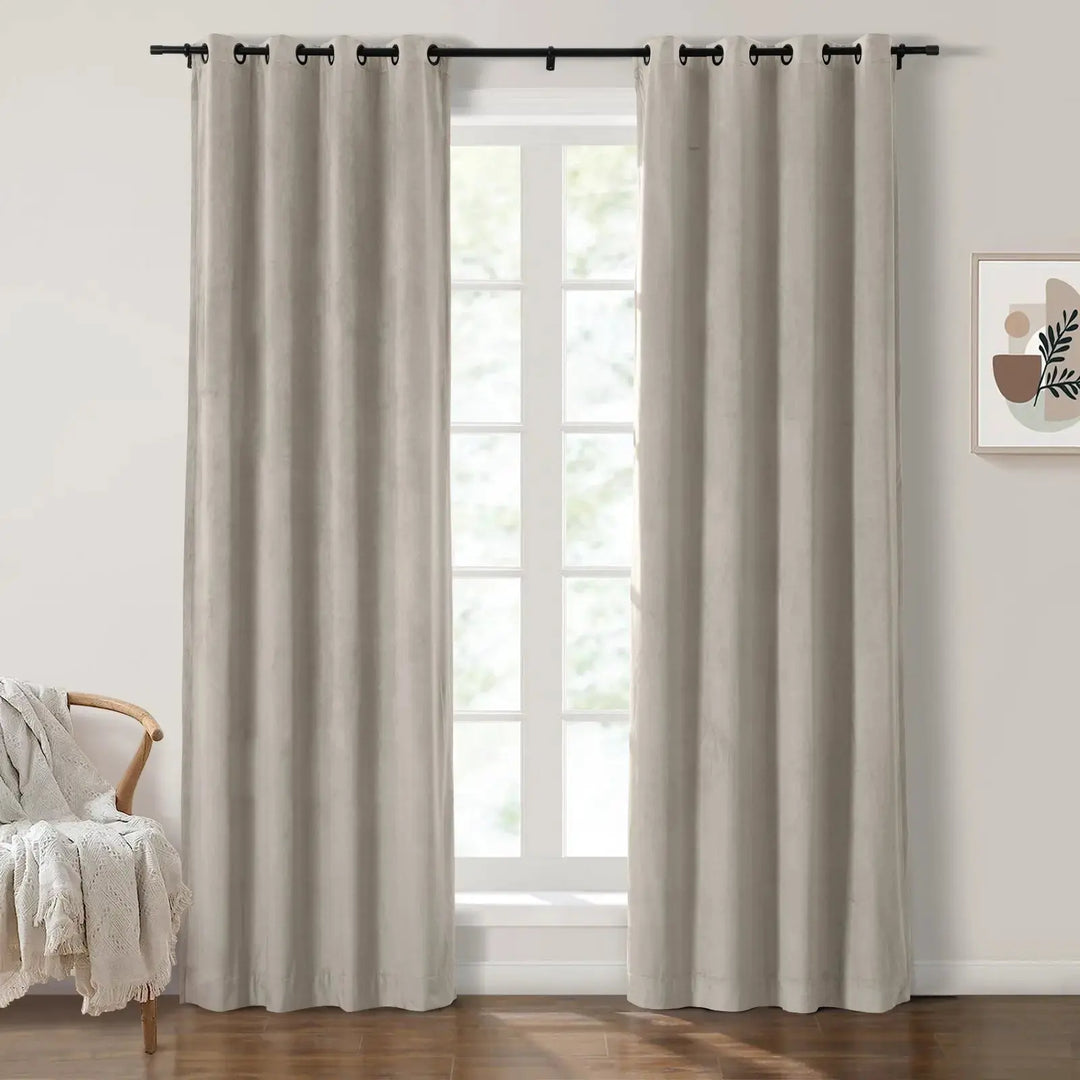 Light beige grommet curtains elegantly framing large windows in a bright living room.