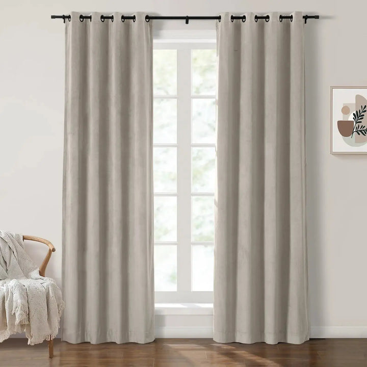 Light beige grommet curtains elegantly framing large windows in a bright living room.