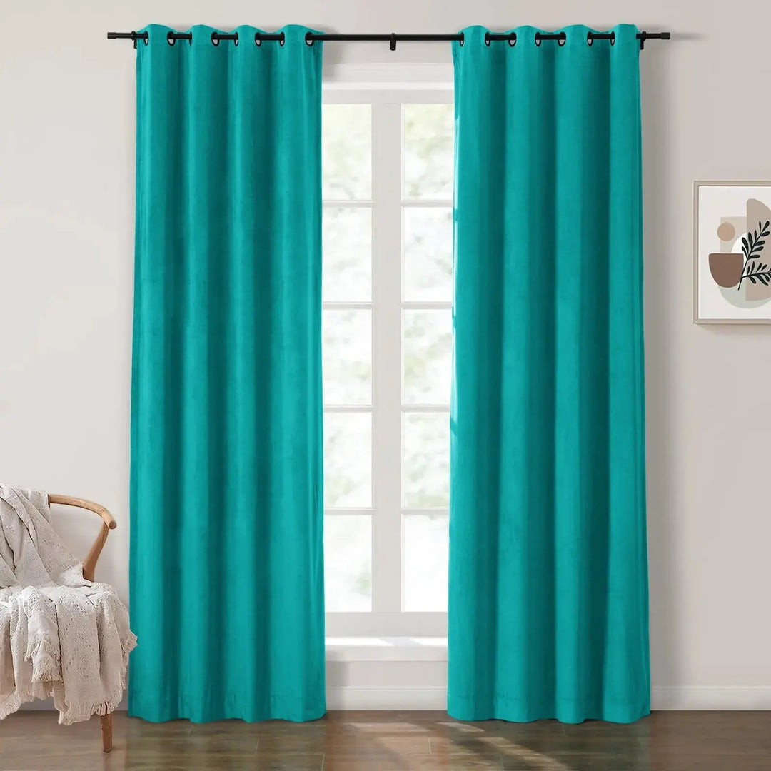 Teal grommet curtains framing large windows in a bright living room.