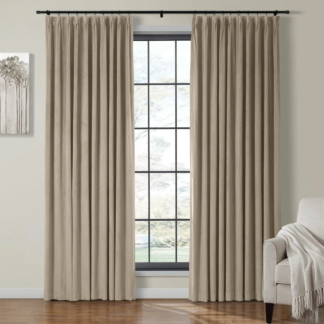 Beige velvet curtains beside a large window in a cozy living room.