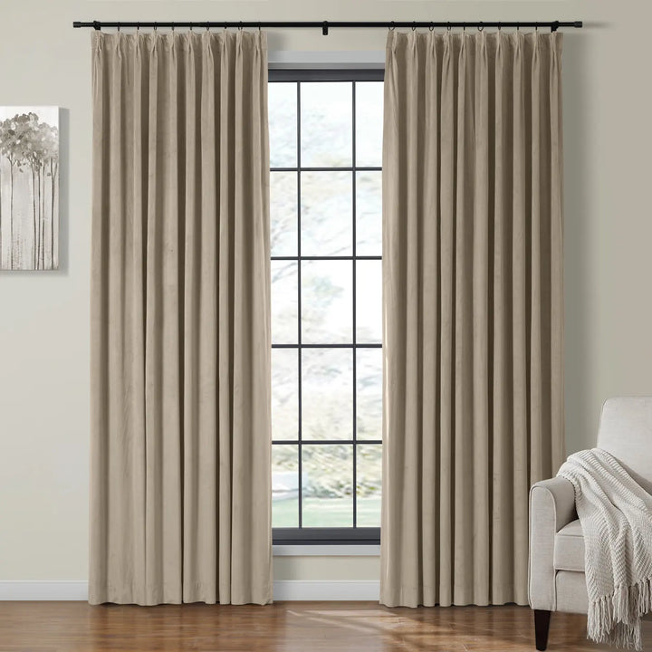Beige velvet curtains beside a large window in a cozy living room.