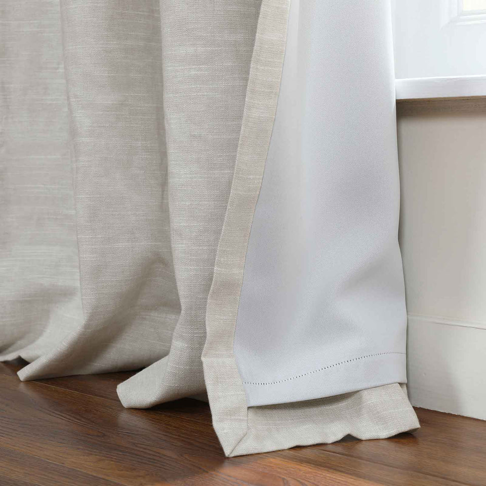 Joy Linen Curtain close-up highlighting hem detail with blackout liner and soft beige fabric.